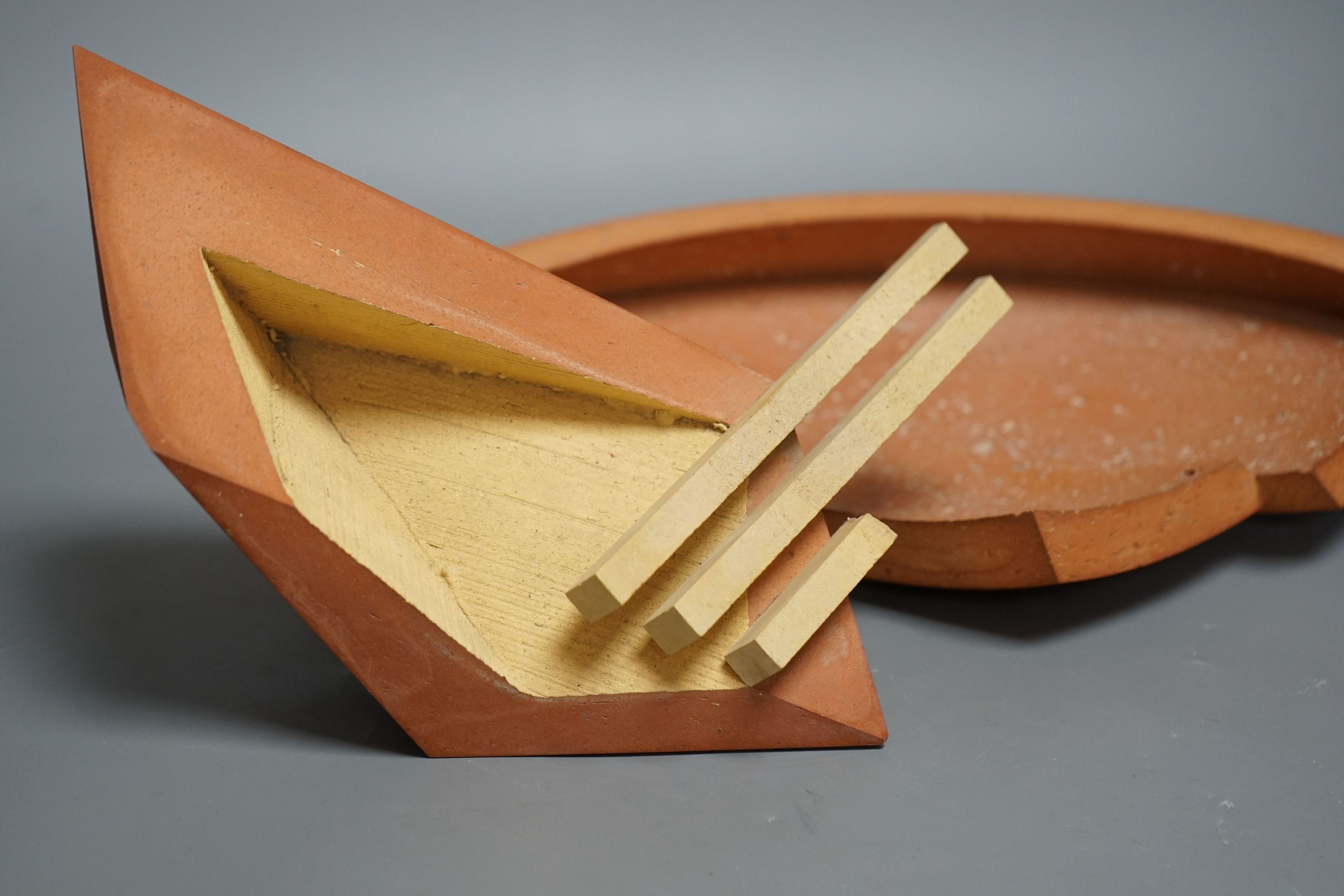 Martin Smith (b.1950), two disk forms, redware, one damaged, with original purchase receipt, largest 37cm wide (2)
